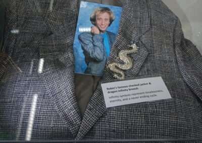 Robin Gibb checked jacket and dragon infinity brooch